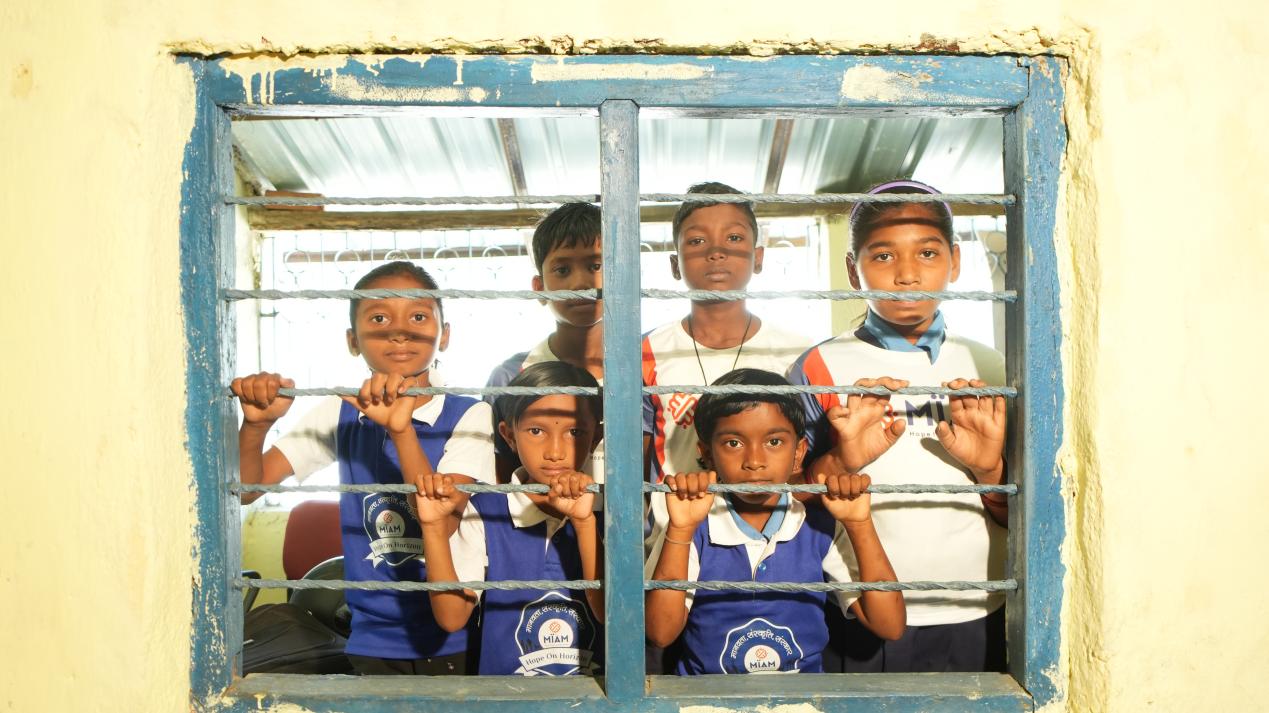 Children looking through school window